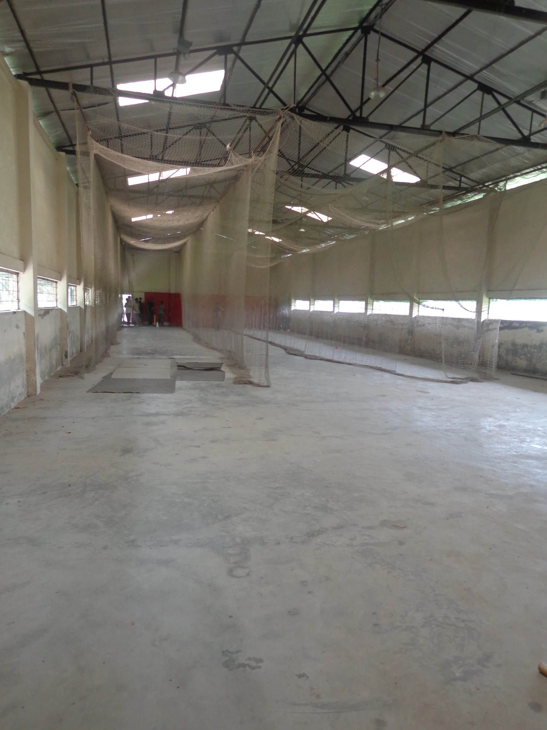 Indoor cricket nets inside a cricket academy hall